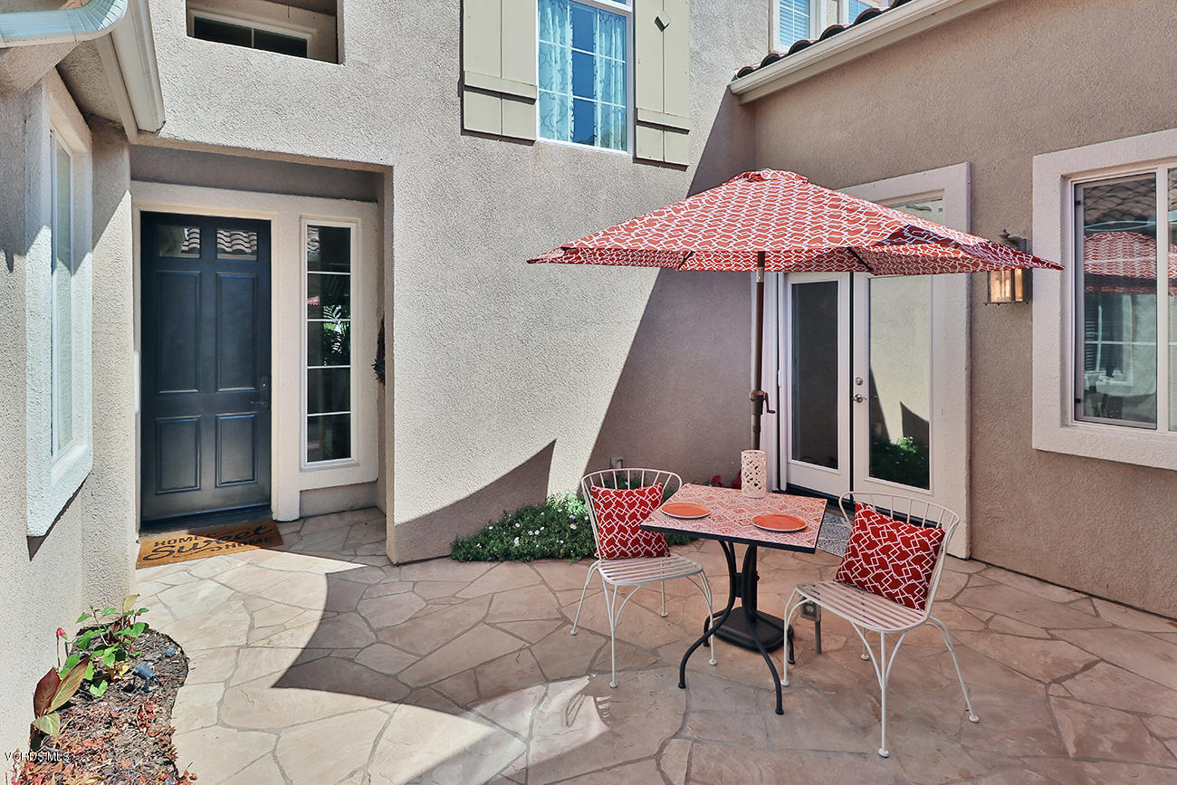 143 Brooks Road Simi Valley, CA 93065 - Photo 4 of 42 a view of a patio with a table and chairs under an umbrella