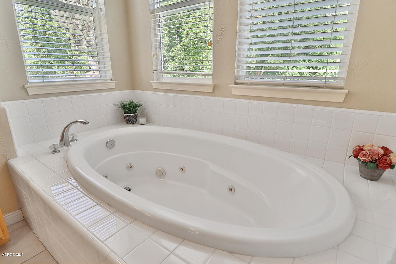 143 Brooks Road Simi Valley, CA 93065 - Photo 31 of 42 a white bath tub sitting in a bathroom next to a window