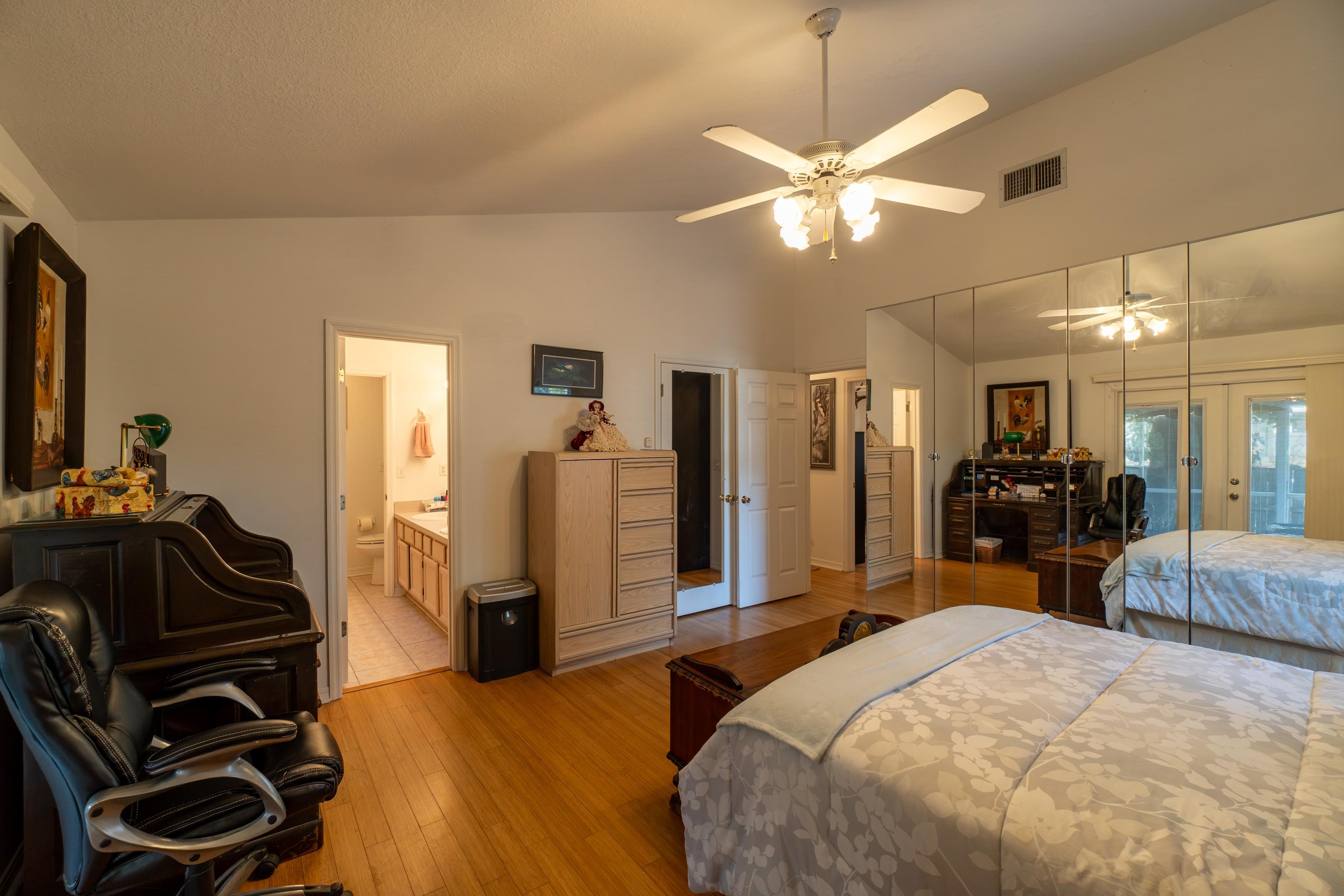 240 Micklers Road St. Augustine, FL 32080 - Photo 39 of 74 a bedroom with a bed and a large mirror with a flat tv screen