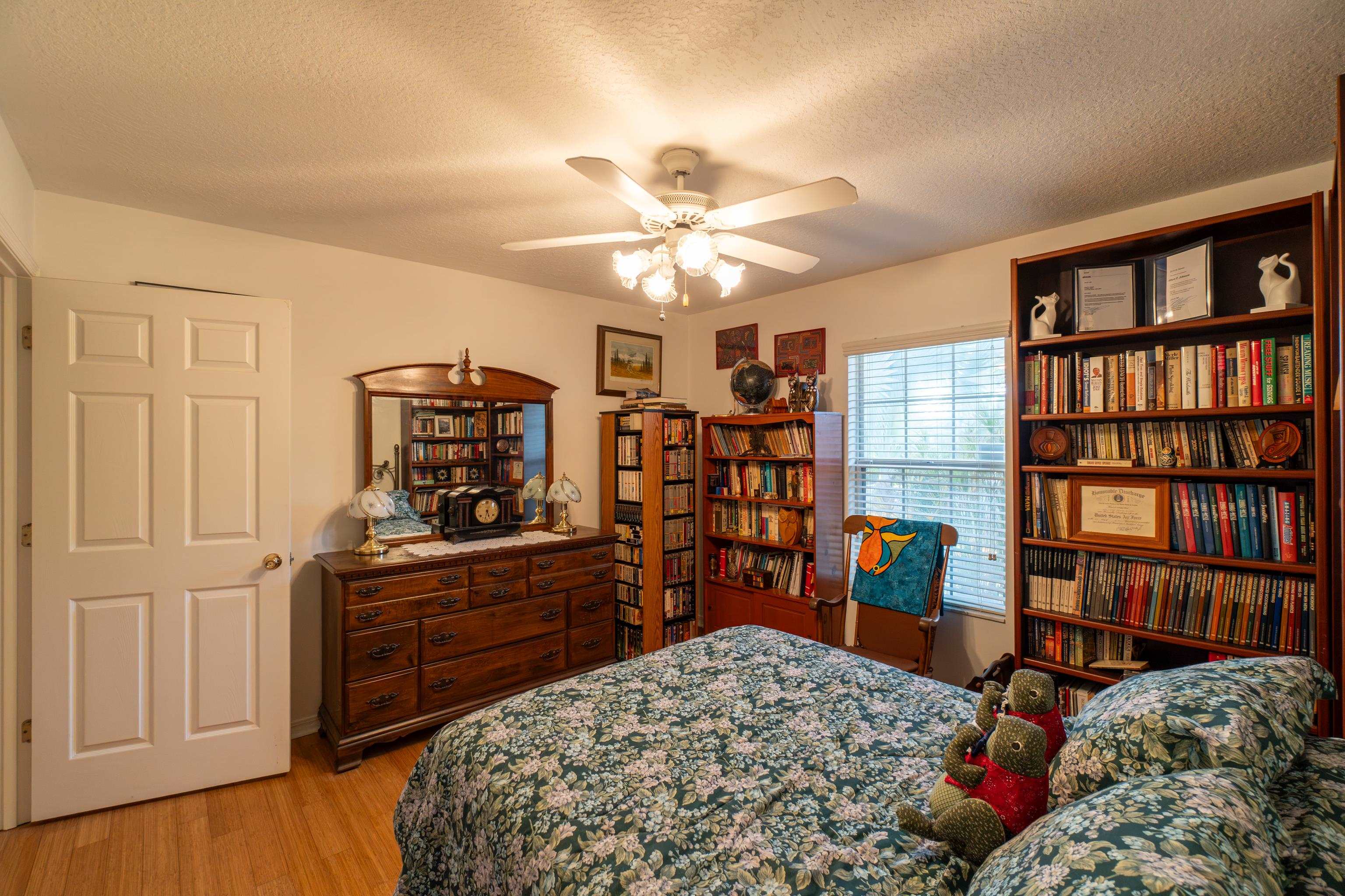240 Micklers Road St. Augustine, FL 32080 - Photo 41 of 74 a bed room with a bed and a book shelf