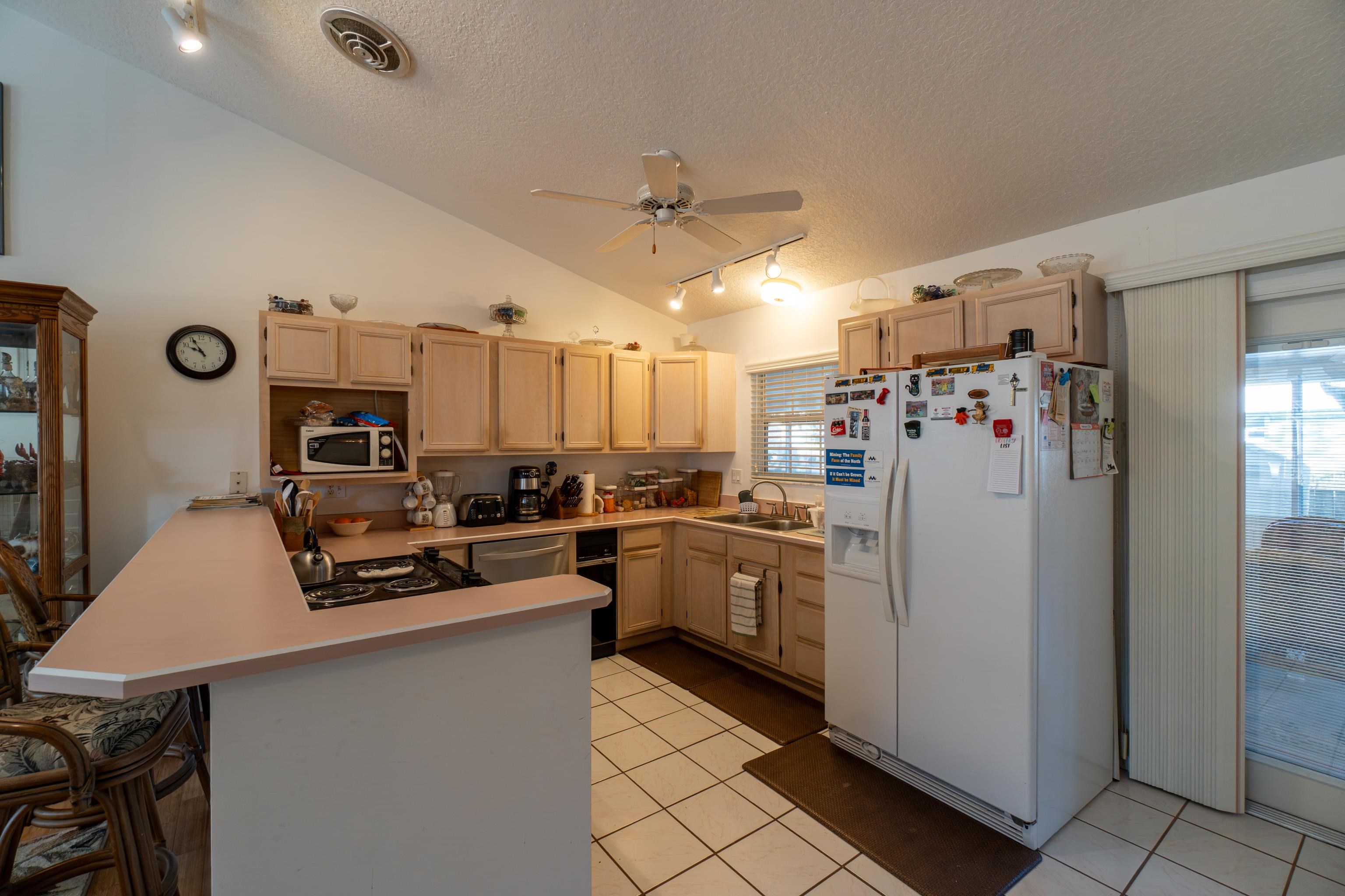 240 Micklers Road St. Augustine, FL 32080 - Photo 53 of 74 a kitchen with refrigerator and cabinets