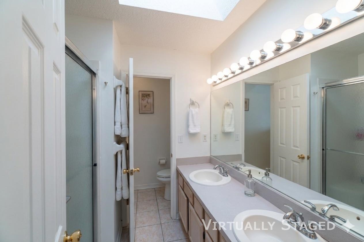 240 Micklers Road St. Augustine, FL 32080 - Photo 70 of 74 a spacious bathroom with a double vanity sink mirror and shower