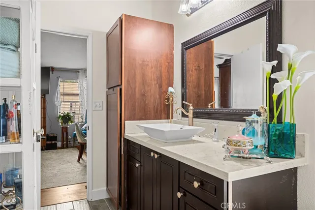 a en suite bathroom with a sink a mirror and a shower
