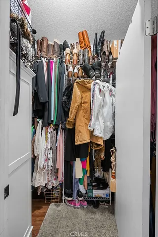 a view of walk in closet with clothes