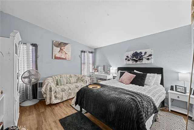 a bedroom with a bed and wooden floor