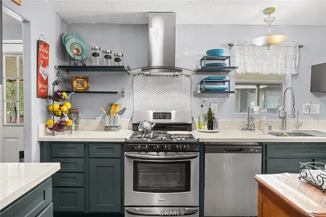 a kitchen with stainless steel appliances granite countertop a sink and a stove