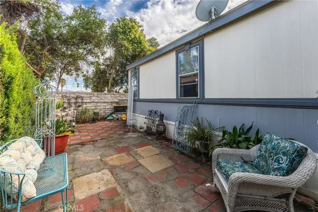 a backyard of a house with outdoor seating