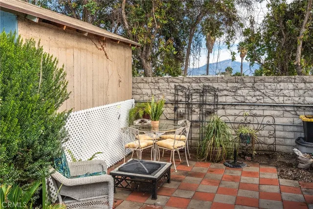 a view of a patio with table and chairs and potted plants