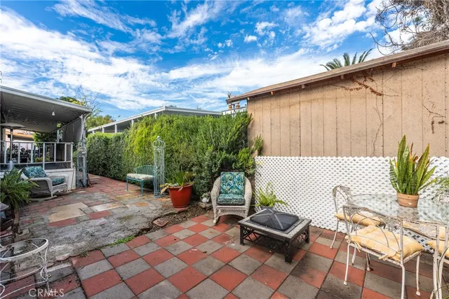 a backyard of a house with outdoor seating