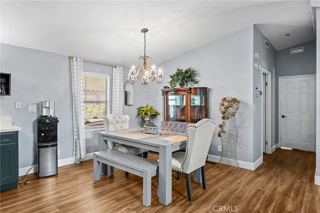 a view of a dining room with furniture wooden floor and chandelier