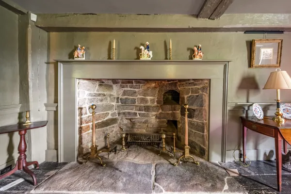 a room with fireplace and a view of bedroom