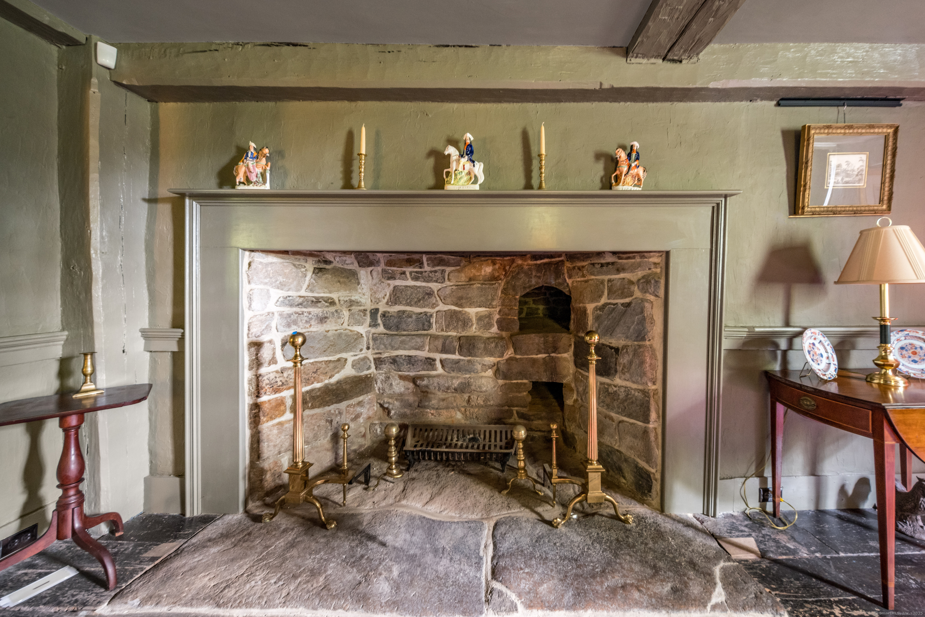 a room with fireplace and a view of bedroom