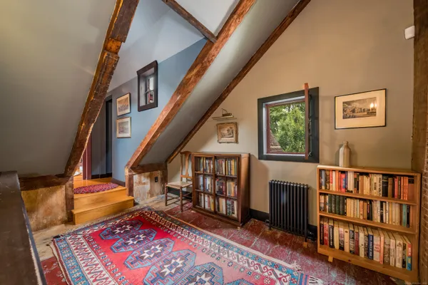 a living room with lots of furniture and a book shelf