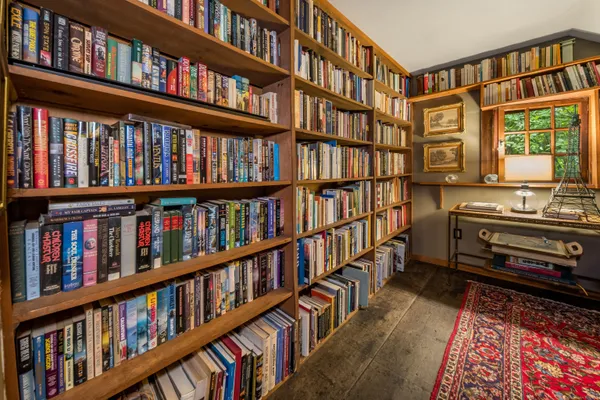 a living room with lots of books