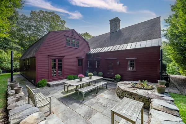 a view of a chairs and table in a backyard