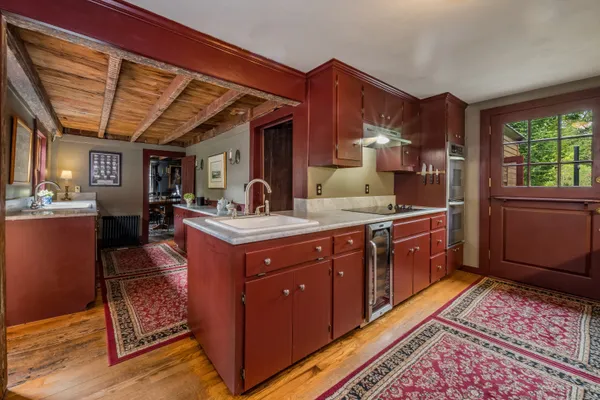 a kitchen with sink and wooden cabinets