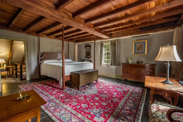 a bedroom with a bed a desk and chair