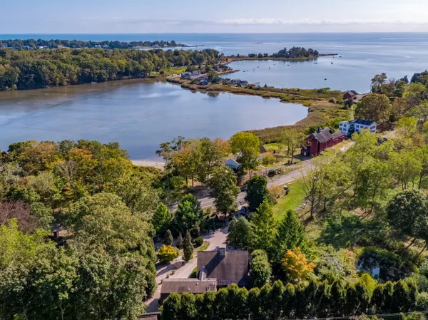 an aerial view of house with yard and mountain view in back