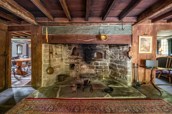 a view of water heater room with wooden floor