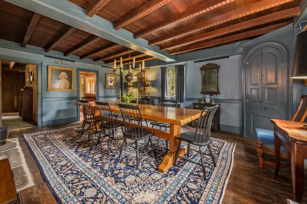 a dining room with furniture window and wooden floor