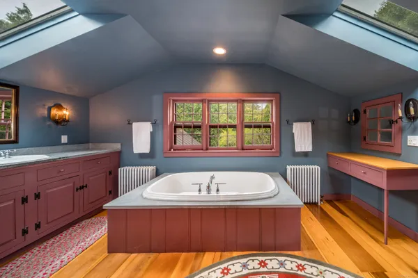 a spacious bathroom with a tub double sink and a large mirror
