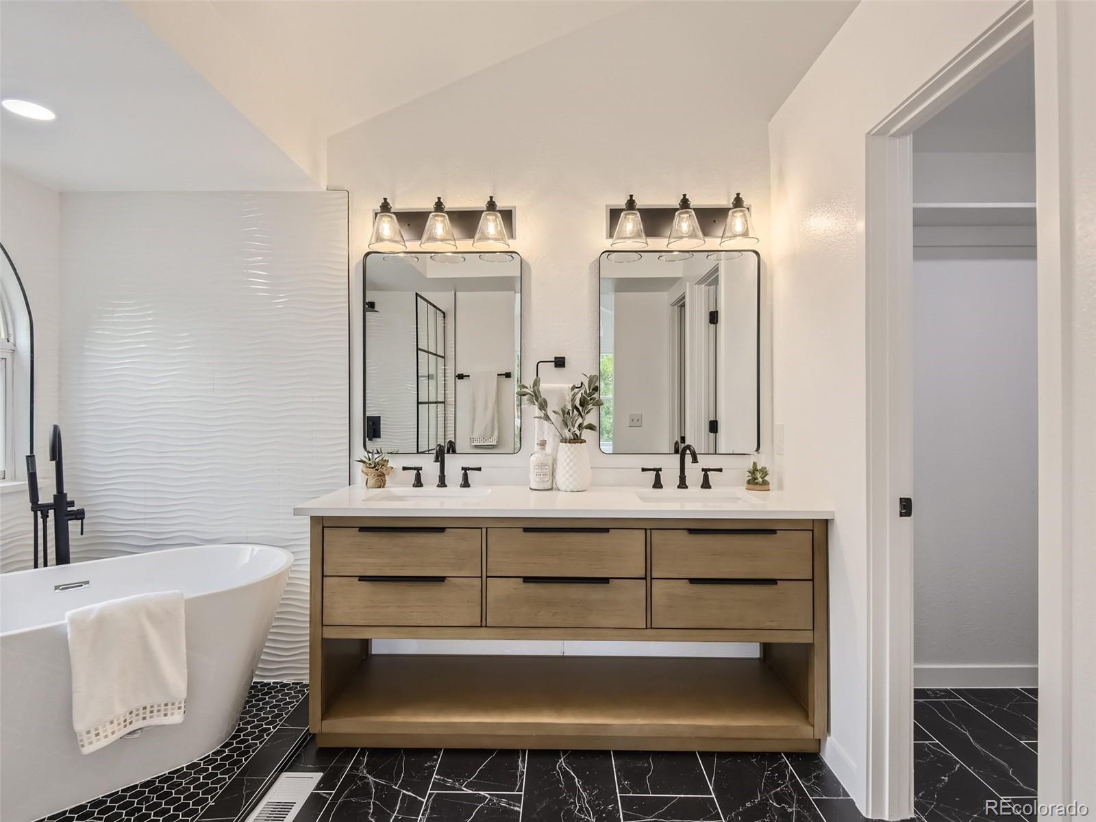6222 Yale Drive Highlands Ranch, CO 80130 - Photo 15 of 32 a bathroom with a double vanity sink mirror and bathtub