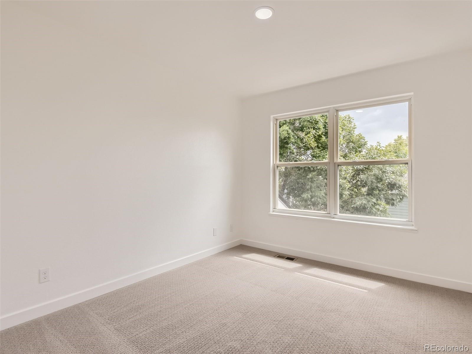 6222 Yale Drive Highlands Ranch, CO 80130 - Photo 18 of 32 an empty room with windows