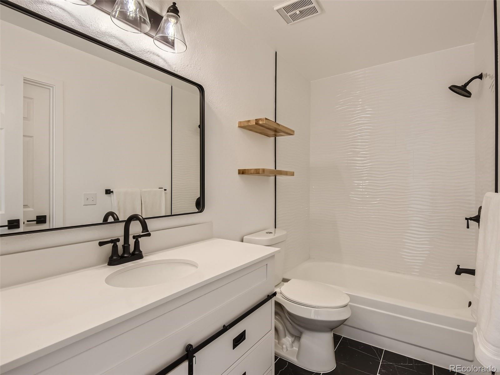 6222 Yale Drive Highlands Ranch, CO 80130 - Photo 19 of 32 a bathroom with a sink a toilet and shower