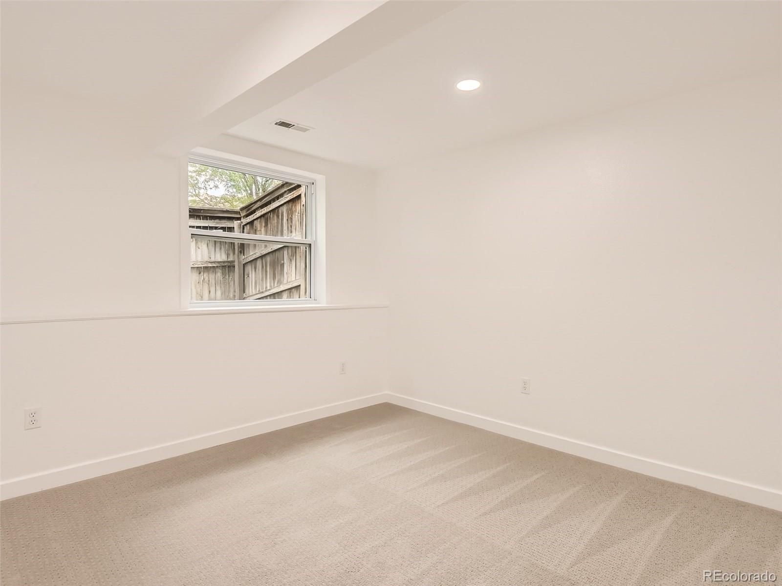 6222 Yale Drive Highlands Ranch, CO 80130 - Photo 20 of 32 an empty room with windows