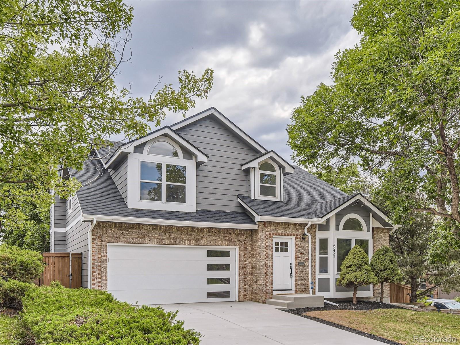 6222 Yale Drive Highlands Ranch, CO 80130 - Photo 2 of 32 a front view of a house with a garden