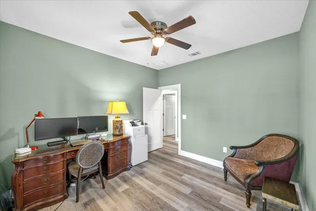 a bathroom with a granite countertop toilet sink and mirror