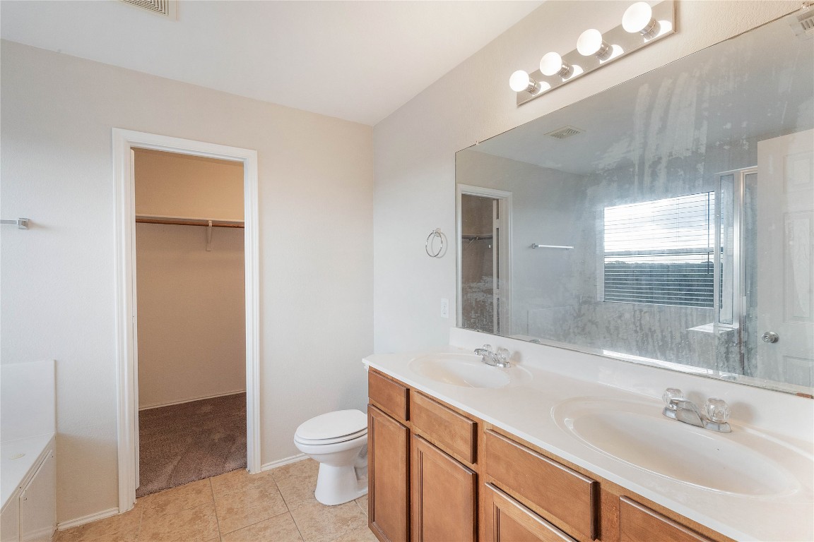 11532 Ashbrook Drive Manchaca, TX 78652 - Photo 11 of 30 a bathroom with a sink a toilet and shower