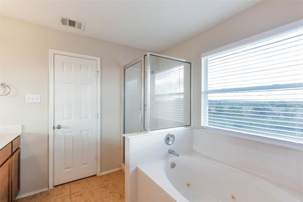 11532 Ashbrook Drive Manchaca, TX 78652 - Photo 12 of 30 a bathroom with a bathtub and a shower