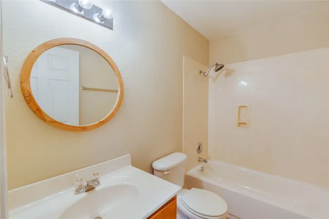 a bathroom with a sink toilet and a mirror