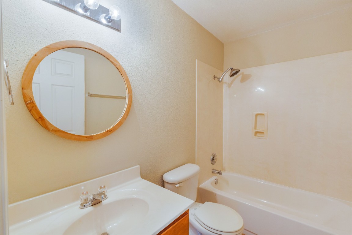 11532 Ashbrook Drive Manchaca, TX 78652 - Photo 16 of 30 a bathroom with a sink toilet and a mirror