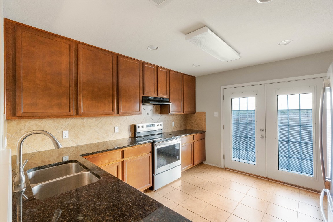 11532 Ashbrook Drive Manchaca, TX 78652 - Photo 2 of 30 a kitchen with stainless steel appliances granite countertop a stove sink and cabinets