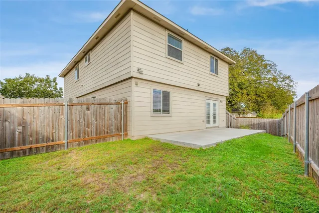 a view of backyard with wooden fence