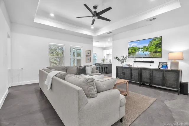 a living room with furniture and a flat screen tv