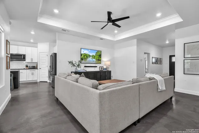 a living room with furniture and kitchen view
