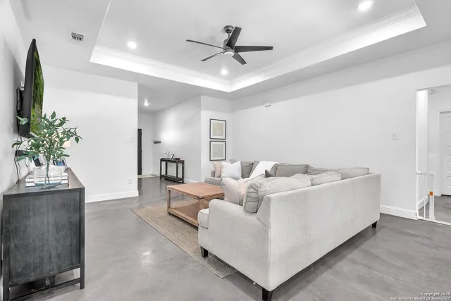 a living room with furniture and a potted plant