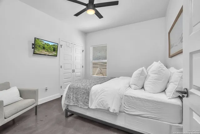 a bedroom with a bed and a couch