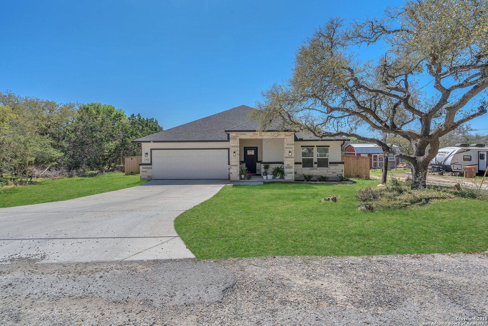 348 Fawn Drive Spring Branch, TX 78070 - Photo 2 of 50 a front view of a house with a garden and yard