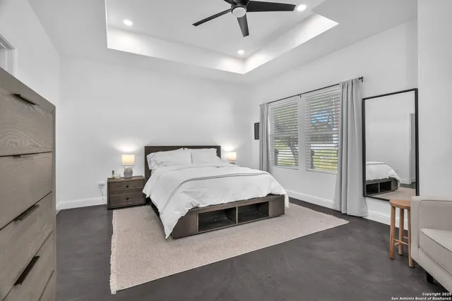 a bedroom with a large bed and a chandelier