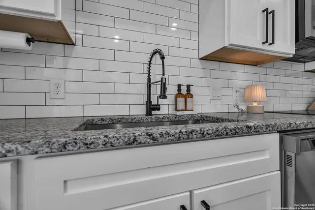 a kitchen with granite countertop cabinets and a stove