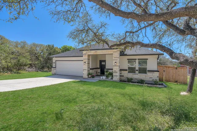 a view of a house with a backyard
