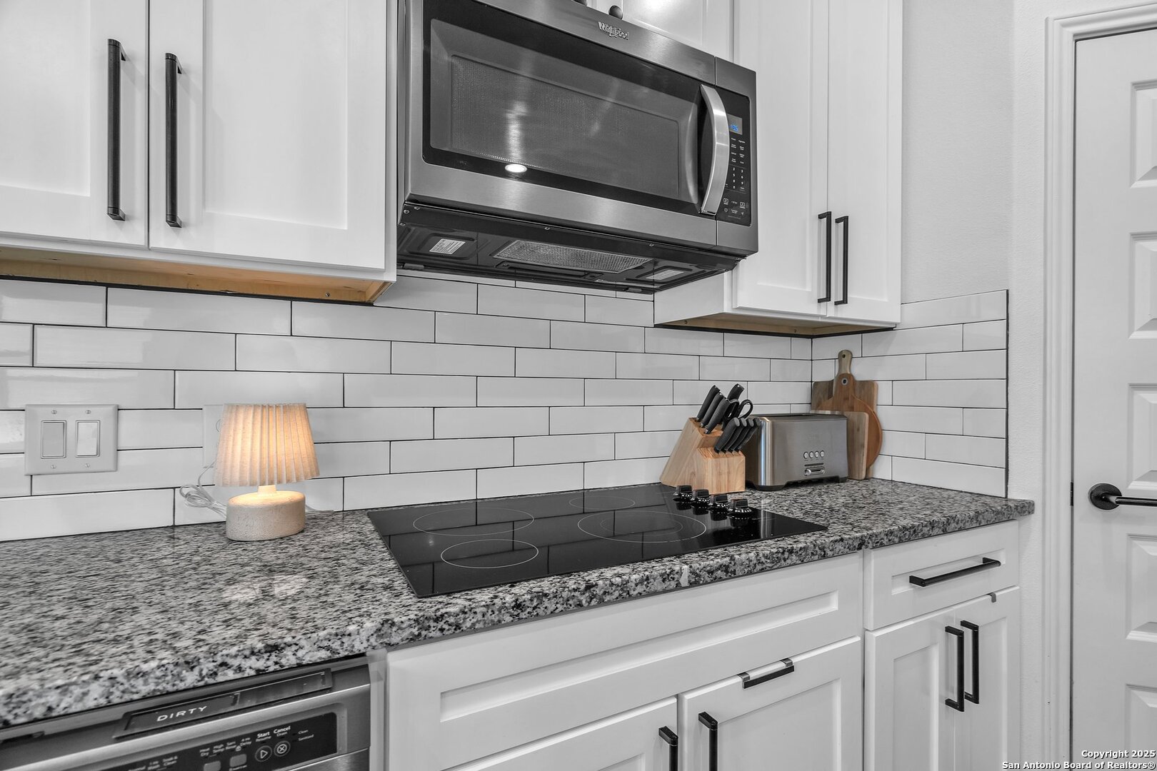 348 Fawn Drive Spring Branch, TX 78070 - Photo 41 of 50 a kitchen with granite countertop white cabinets stainless steel appliances and a sink