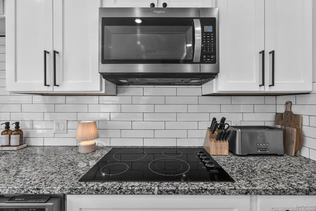 a kitchen with a stove microwave and sink