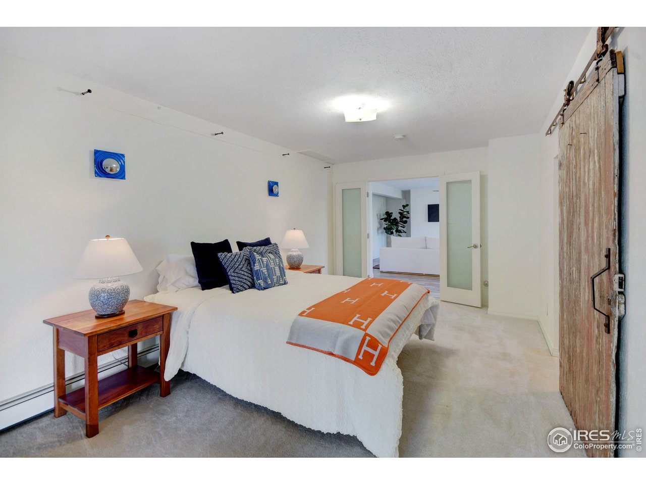 703 Apple Valley Road Lyons, CO 80540 - Photo 22 of 40 a bedroom with bed and a night stand