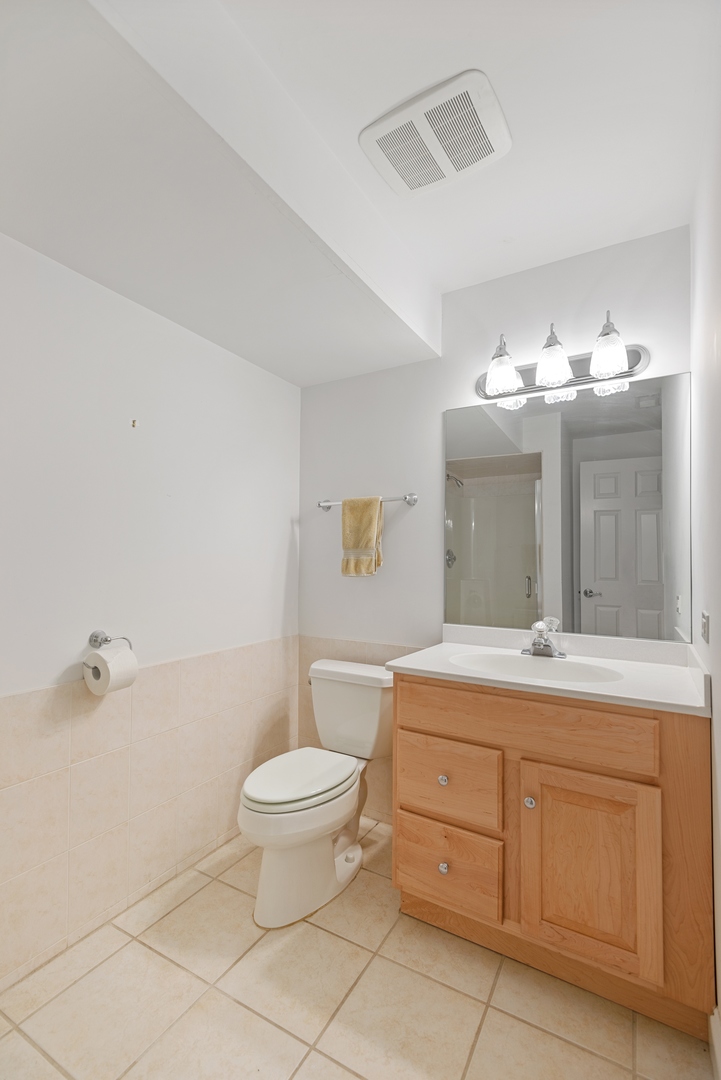 463 Green Bay Road Highland Park, IL 60035 - Photo 15 of 27 a spacious bathroom with a granite countertop sink a toilet and a mirror