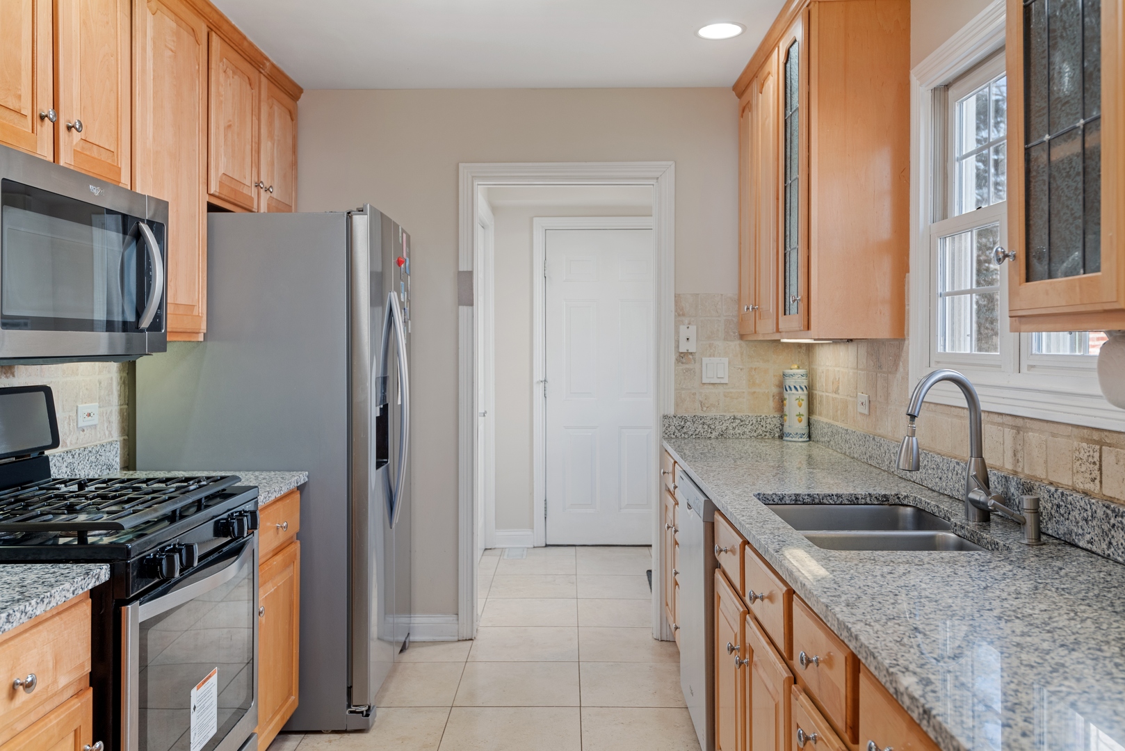 463 Green Bay Road Highland Park, IL 60035 - Photo 3 of 27 a kitchen with stainless steel appliances granite countertop a sink stove and refrigerator